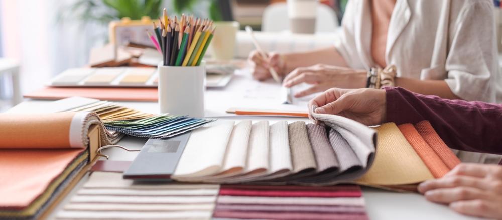 A designer working with textile samples.